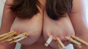 Laly Prin puts on nipple clamps